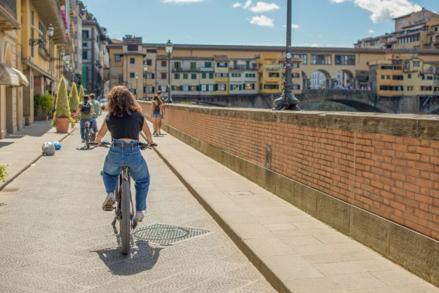 Florence: Guided Electric Bike Tour with Gelato - Riding back through Florence: Lungarno riverside streets